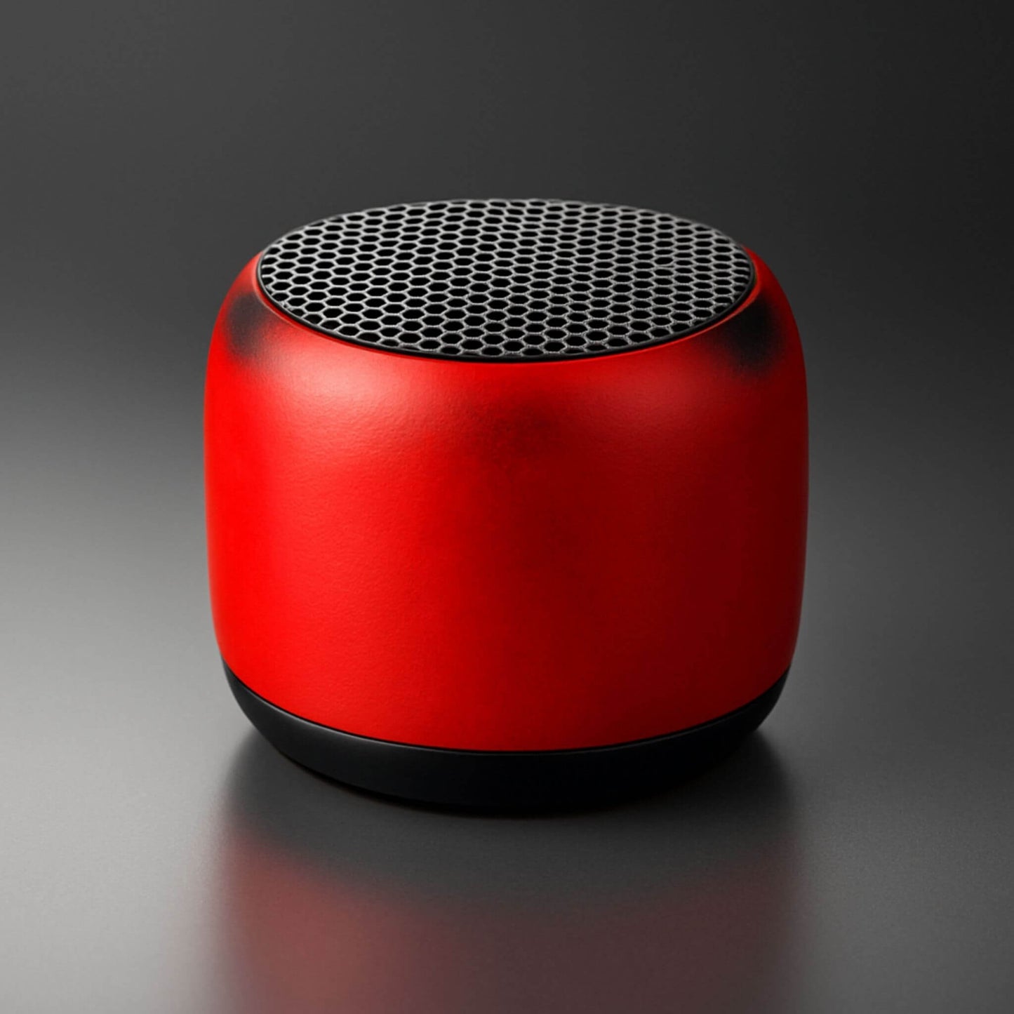 REXSAR M1 Mini Speaker, a compact red metal Bluetooth speaker with a mesh grille